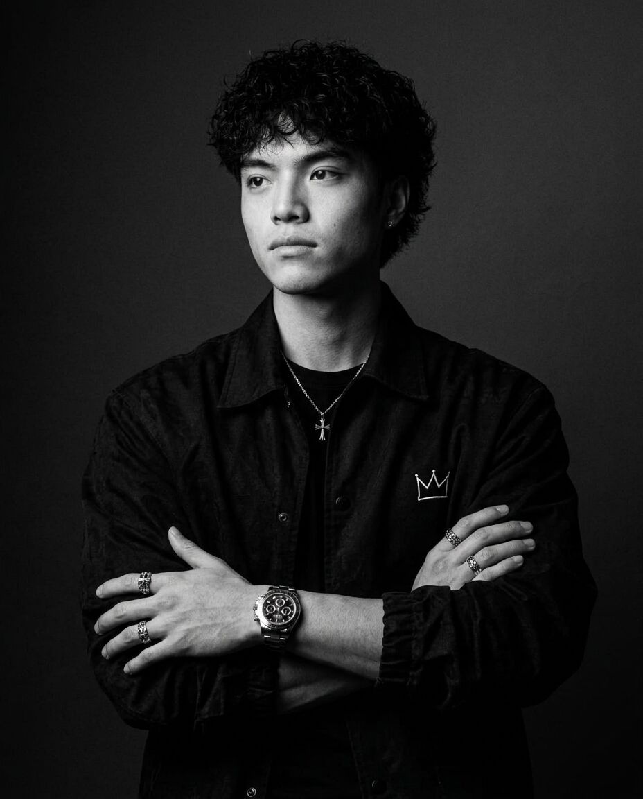 Black-and-white portrait of Kimchi with arms crossed, chronograph visible on his wrist